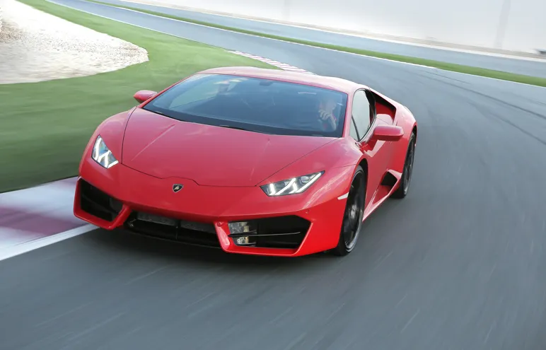 A red sports car on an open road